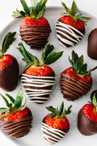 strawberries covered in dark chocolate and drizzled with white and milk chocolate