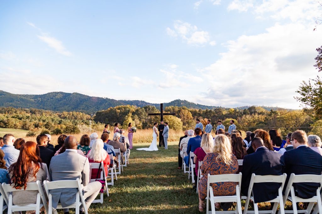 Wedding ceremony, couple standing under a cross.