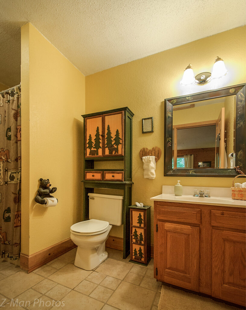 A standard bathroom with a toilet, sink, and mirror