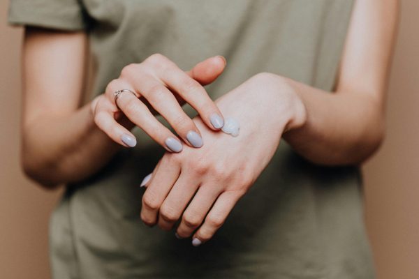 pexels-photo-4210660-4210660 Crop anonymous female in casual shirt with manicured hands and ring softly rubbing hand moisturizer in back of hand skin